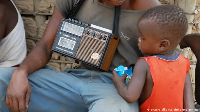 Man and a child with an old radio