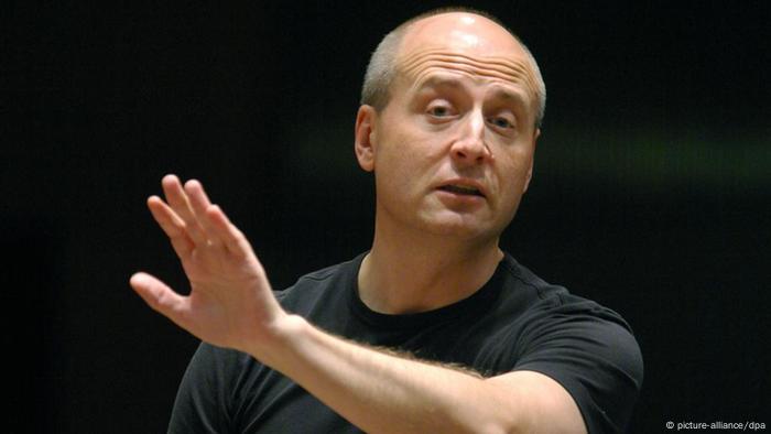 Paavo Järvi with his hand held high while conducting