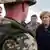 German Chancellor Angela Merkel, center, talks with German soldiers in Kunduz