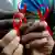 Руки с красными ленточками - символом борьбы со СПИДом