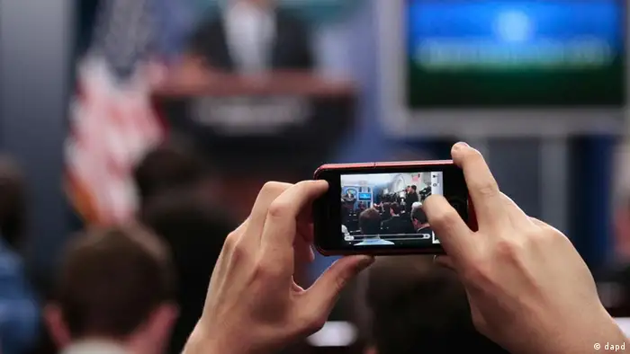 A member of the press corps uses their smartphone to take a picture of President Barack Obama in the White House briefing room in Washington, Tuesday, April, 5, 2011. Obama surprised members of the media by making an unannounced visit to the briefing room to talk about the budget. (ddp images/AP Photo/Pablo Martinez Monsivais)
