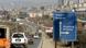 Cars on a highway drive past a sign with arrows pointing to Belgrade and Pristina Cars on a highway drive past a sign with arrows pointing to Belgrade and Pristina