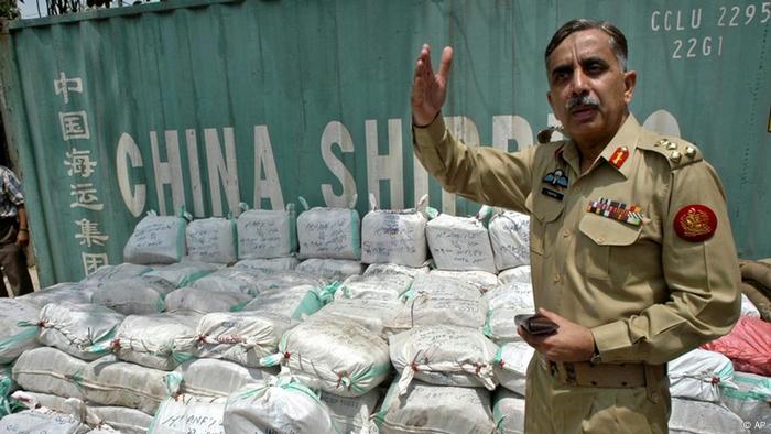 Pakistani Brigadier General Ashfaqur Rashid Khan stands before drug cargo detected in a shipping container by his anti-narcotics unit