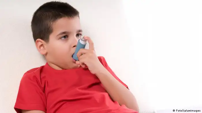 A child who suffers from asthma uses an inhaler. 