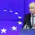 European Council President Herman Van Rompuy with an EU flag next to him