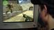 A boy plays a computer gayme, killing the opponent from a first person's perpective. A boy plays a computer gayme, killing the opponent from a first person's perpective.