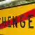 Дорожный знак с надписью "Шенген", перечеркнутой красной линией