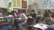 Elevi într-o clasă de curs, alături de învățătoare Elevi într-o clasă de curs, alături de învățătoare