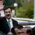 Pakistani Prime Minister Yousuf Raza Gilani waves upon his arrival at the Supreme Court in Islamabad