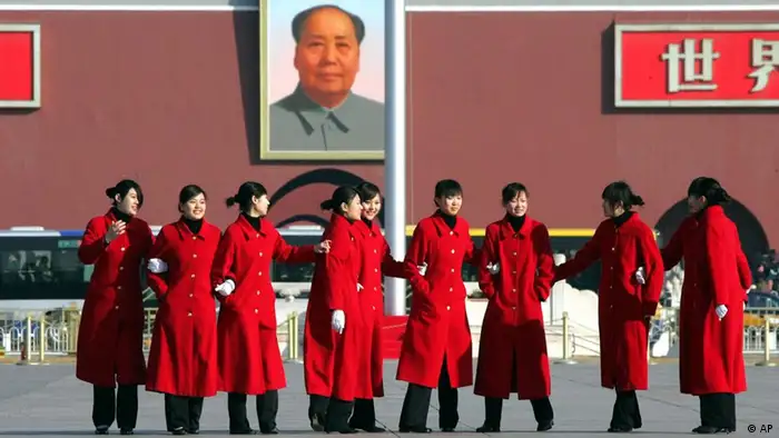 A group of attendants line up for a group photo in Tiananmen Square, during the fourth day of the National People's Congress, China's parliament, in Beijing Thursday March 8, 2007. The attendants were waiting to escort delegates from the congress, in the adjacent Great Hall of the People, back to their buses. (AP Photo/Greg Baker)