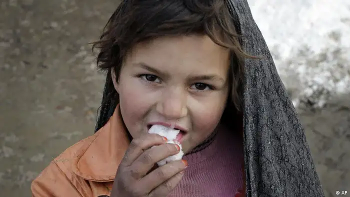 An Afghan refugee girl, looks on camera as she tastes snow at a refugee camp after a snowfall in Kabul, Afghanistan, Thursday, Jan. 5, 2012. (AP Photo/Musadeq Sadeq)