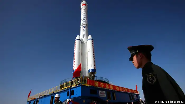 A Long March 2F (CZ-2F) carrier rocket carrying the Shenzhou VIII spacecraft is being moved to the launch pad at the Jiuquan Satellite Launch Center near Jiuquan city, northwest Chinas Gansu province, 26 October 2011. China will launch the Shenzhou VIII (Shenzhou-8) spacecraft in early November at the Jiuquan Satellite Launch Center in northwest China. The spacecraft is expected to perform Chinas first space docking with Tiangong-1, or Heavenly Palace-1, a space lab module that was launched in September from the same launch center.