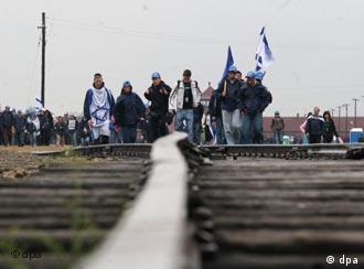 Participants walk along railway tracks in Auschwitz on Thursday