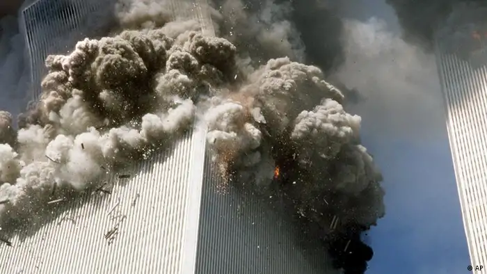 **FILE** The south tower of New York's World Trade Center, left, begins to collapse after a terrorist attack on the buildings as shown in this Sept. 11, 2001, file photo. Federal investigators believe the second World Trade Center tower fell much more quickly than the first because it faced a more concentrated, intense fire inside, officials said Tuesday. Oct. 19, 2004. Investigators have singled out this Associated Press photograph that they said may provide evidence to support their theory which shows a kink in the building's corner at the 106th floor. (AP Photo/Gulnara Samoilova, FILE)