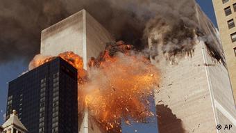 **FILE** The south tower of New York's World Trade Center, left, begins to collapse after a terrorist attack on the buildings as shown in this Sept. 11, 2001, file photo. Federal investigators believe the second World Trade Center tower fell much more quickly than the first because it faced a more concentrated, intense fire inside, officials said Tuesday. Oct. 19, 2004. Investigators have singled out this Associated Press photograph that they said may provide evidence to support their theory which shows a kink in the building's corner at the 106th floor. (AP Photo/Gulnara Samoilova, FILE)