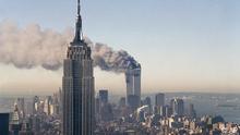 The twin towers of the World Trade Center burn behind the Empire State Building in New York, Sept. 11, 2001. In a horrific sequence of destruction, terrorists crashed two planes into the World Trade Center causing the twin 110-story towers to collapse. (AP Photo/Marty Lederhandler)