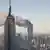 Вид на Empire State Building и горящие башни Всемирного торгового центра 11 сентября 2001 года