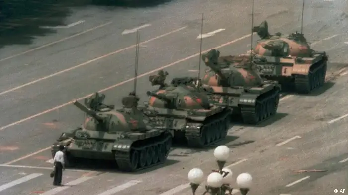 A Chinese man stands alone to block a line of tanks heading east on Beijing's Cangan Blvd. in Tiananmen Square on June 5, 1989. The man, calling for an end to the recent violence and bloodshed against pro-democracy demonstrators, was pulled away by bystanders, and the tanks continued on their way. The Chinese government crushed a student-led demonstration for democratic reform and against government corruption, killing hundreds, or perhaps thousands of demonstrators in the strongest anti-government protest since the 1949 revolution. Ironically, the name Tiananmen means Gate of Heavenly Peace. (AP Photo/Jeff Widener)