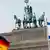 German and Israeli flags with the Brandenburg Gate in the background