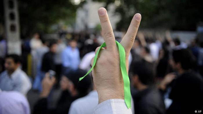 Bei den Protesten im Iran nach den Präsidentschaftswahlen 2009 reckt ein Mussawi-Anhänger seine Hand mit einer grünen Schleife zum Victory-Zeichen in die Luft (Foto: AP)