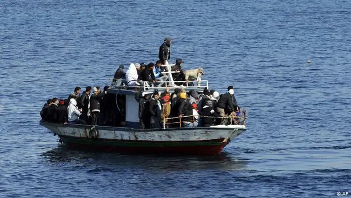 A boatload of would-be migrants believed to be from North Africa is seen moments before being rescued by the Italian Coast Guard in the waters off the Sicilian island of Lampedusa, Italy, Sunday, Feb. 13, 2011. By dawn Saturday, around 3,000 migrants fleeing turmoil in North Africa had arrived by boat on Lampedusa over three days, hundreds more arrived during the day and several more boats were reportedly spotted on the horizon headed for the flat-rock, largely barren fishing island, Italian authorities said. (ddp images/AP Photo/Daniele La Monaca)