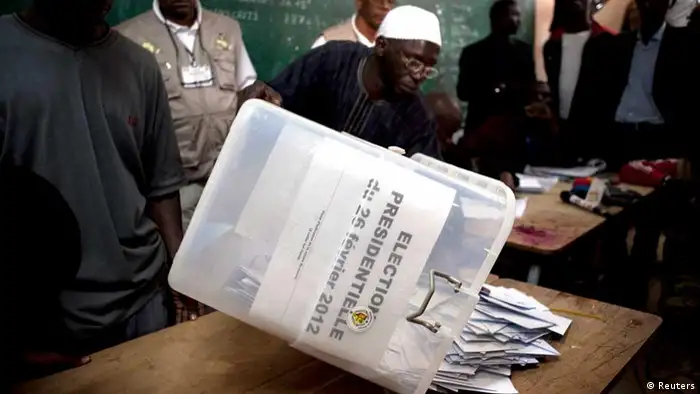 A Senegalese electoral official empties a ballot box on a table for counting during presidential elections in the capital Dakar February 26, 2012. Senegal's incumbent President Abdoulaye Wade, who is seeking to extend his 12-year rule in the West African state despite complaints he is violating term limits, was heckled by scores of voters as he cast his ballot on Sunday. REUTERS/Joe Penney (SENEGAL - Tags: POLITICS ELECTIONS)