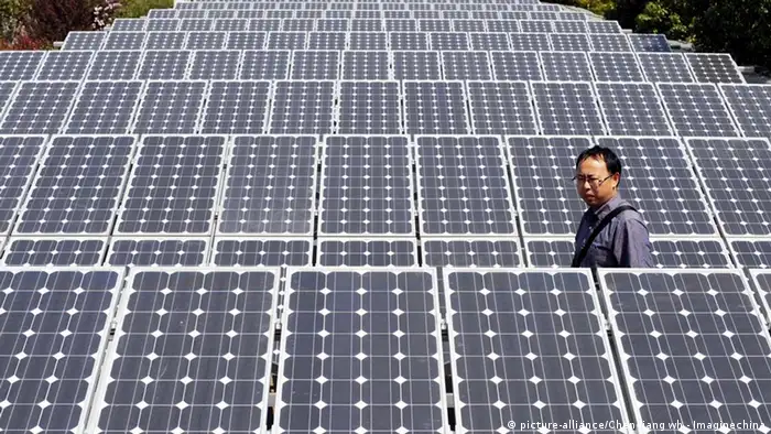 --FILE-- A Chinese man walks amid solar panels at a solar power facility in Wuhan city, central Chinas Hubei province, March 19, 2010. The focus of solar farm developments is shifting and North America and the Asia-Pacific are set to surpass Europe - the traditional front runner of clean energy adoption - as the areas of fastest-growing solar power installations. According to a Merrill Lynch report, China, India, Japan and South Korea are together projected to have 6,300 megawatts (MW) of solar panel installations by 2012, up almost tenfold from 650 MW last year. China alone is forecast to show 20-fold growth in installations to 4,000 MW, while the US and Canada are projected to see their combined solar panel installations surge eightfold to 4,400 MW from 550 MW.