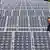 Chinese steht zwischen mehreren Solarzellen