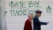 An elderly couple pass a stuttered store, spray-painted with the slogan "Eat the rich" in central Athens, on Monday, May 3, 2010. Greece on Sunday announced more austerity measures to be achieved through public service and pension pay cuts, higher taxes and streamlining government. Greece has been promised a total of euro 110 billion ($133 billion) in loans by the eurozone countries and the International Monetary Fund. (AP Photo/Petros Giannakouris) An elderly couple pass a stuttered store, spray-painted with the slogan "Eat the rich" in central Athens, on Monday, May 3, 2010. Greece on Sunday announced more austerity measures to be achieved through public service and pension pay cuts, higher taxes and streamlining government. Greece has been promised a total of euro 110 billion ($133 billion) in loans by the eurozone countries and the International Monetary Fund. (AP Photo/Petros Giannakouris)