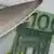 Острый нож на фоне банкноты евро