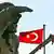 Monument in Ankara, in front of two Turkish flags. (Photo: Tarik Tinazay dpa)