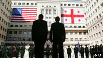 US President George W. Bush with Georgian President Saakashvili in front of giant American and Georgian flags