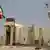 An Iranian flag flutters in front of the reactor building of the Bushehr nuclear power plant