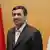Iranian President Mahmoud Ahmedinejad flanked by a Turkish and an Iranian flag
