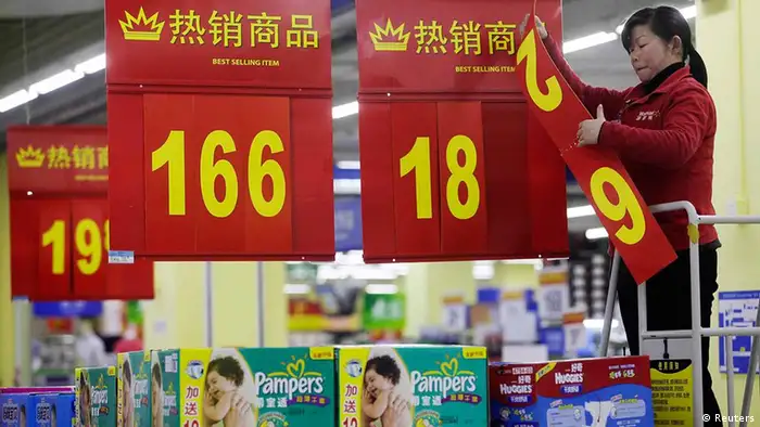 An employee changes a price label at a supermarket in Wuhan, Hubei province March 9, 2012. China's annual inflation cooled sharply to a 20-month low of 3.2 percent in February as food price pressures eased after the Lunar New Year holiday, giving Beijing room to loosen monetary policy if needed. REUTERS/Stringer (CHINA - Tags: BUSINESS FOOD) CHINA OUT. NO COMMERCIAL OR EDITORIAL SALES IN CHINA