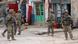 U.S. soldiers stand guard at the scene of a suicide attack U.S. soldiers stand guard at the scene of a suicide attack