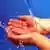 Berlin: Das symbolhafte Foto zeigt zusammen gehaltene Hände, die einen Wasserstrahl aus einem Wasserhahn auffangen. (BRL451-160603)