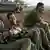 Israeli soldiers relax at a military staging area near Kibbutz Mefalsim, in southern Israel on the border with the Gaza Strip, Sunday, Nov. 26, 2006. (Photo: Oded Blilty)