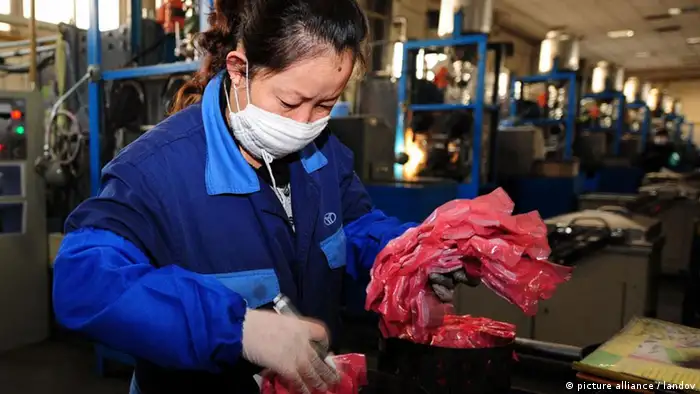 A worker packs semi-finished products which consist of rare earths at a workshop in Baotou City of north China's Inner Mongolia Autonomous Region, Oct. 29, 2010. Rare earths, a class of 17 chemical elements, have become increasingly important in manufacturing sophisticated products, including flat-screen monitors, electric car batteries, wind turbines, missiles and aerospace alloys. As the high-tech industry developed rapidly in recent years, the global demand and consumption of rare earths grew fast. However, mining these minerals, which are vital for developing a green world, took a toll on environment. Lax environmental standards and a low industry threshold led to serious overcapacity in China's rare earth market in the past two decades. Excessive and disordered mining of this non-renewable resource then caused environmental degradation and serious resource wastes. Because of the backward mining technologies, half of the resources were wasted during extraction and processing and the environment was damaged. Although China worked to improve mining methods and minimize environmental damage, experts said pollution was still inevitable during the mining process.