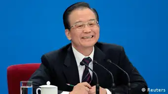 China's Premier Wen Jiabao smiles as he delivers a speech at a news conference after the closing ceremony of the National People's Congress (NPC) at the Great Hall of the People in Beijing March 14, 2012. REUTERS/Jason Lee (CHINA - Tags: POLITICS)
