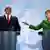 Bundeskanzlerin Angela Merkel (r.) zeigt in Richtung des tunesischen Ministerpräsidenten Hamadi Jebali. Beide stehen hinter Sprechpulten im Berliner Kanzleramt. Hinter ihnen sind die deutsche und tunesische Flagge zu sehen. (Foto: REUTERS)