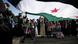 Syrian protesters chant anti-Bashar Assad slogans under a large revolutionary flag during a protest in front the Syrian embassy in Amman, Jordan, Friday, March 9, 2012. Hundreds of Syrians attend the Friday prayer, prior to a protest in front the Syrian embassy to demand International intervention and to arm the Free Syrian Army. (AP photo/Mohammad Hannon) Syrian protesters chant anti-Bashar Assad slogans under a large revolutionary flag during a protest in front the Syrian embassy in Amman, Jordan, Friday, March 9, 2012. Hundreds of Syrians attend the Friday prayer, prior to a protest in front the Syrian embassy to demand International intervention and to arm the Free Syrian Army. (AP photo/Mohammad Hannon)