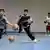 Children practice dribbling in a gymnasium in Baglar