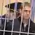 epa02917474 Terrorism suspect Vladislav Kovalyov stands in a barred cage prior to a court session in Minsk, Belarus, on 15 September 2011. Dmitri Konovalov and Vladislav Kovalyov are charged with terrorism, including the explosion in the Oktyabrskaya metro station in Minsk on 11 April 2011, that killed 15 people and left more than 300 wounded. If found guilty, they could face the death penalty. EPA/TATYANA ZENKOVICH +++(c) dpa - Bildfunk+++