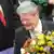 Joachim Gauck holds flowers after he was elected German president at Germany's Federal Assembly in Berlin, March 18, 2012. German lawmakers elected Joachim Gauck, a former Lutheran pastor and human rights activist from communist East Germany, as president of the European Union's largest country on Sunday by a large majority in a first round of voting. REUTERS/Fabian Bimmer (GERMANY - Tags: POLITICS ELECTIONS)