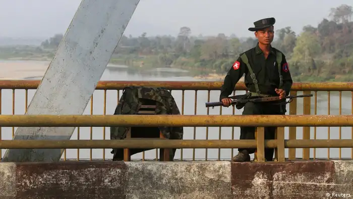 A Myanmar government soldier stands guard on Balaminhtin bridge over the Irrawaddy River near the city of Myitkyina in the north of the country after months of renewed fighting between government troops and the Kachin Independence Army, or KIA, February 22, 2012. Set up in the early 1960s, the KIA is one of the biggest ethnic armed groups that still has not signed a peace agreement with the government. There have been fierce battles between the KIA and government troops since last year while representatives from both sides have been holding peace talks for about six times, including twice in Ruili, a border town in neighbouring China. At the same time, thousands of local people have fled to Chinese border and bigger towns inside the Kachin State to escape the battle.REUTERS/Strinter (MYANMAR - Tags: MILITARY POLITICS SOCIETY)