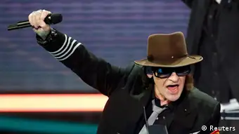 German rock musician and composer Udo Lindenberg holds his trophy at the Echo Music Awards ceremony Berlin March 22, 2012. Established in 1992, the German Phonographic Academy honours national and international artists with the Echo German music prize. REUTERS/Fabrizio Bensch (GERMANY - Tags: ENTERTAINMENT) (ECHO-WINNERS)