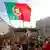 Demonstrators wave a Portuguese flag outside parliament