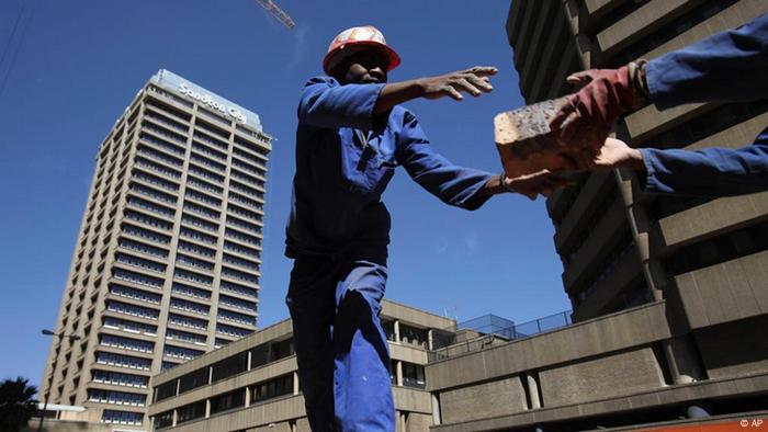 Workers transfer bricks at a construction site, Tuesday, Aug. 18, 2009 in Johannesburg, South Africa. Africa's largest economy shrunk by 3 percent in the second quarter, according to South African government figures released Tuesday, more evidence of the impact the global recession is having on the continent. (ddp images/AP Photo/Karel Prinsloo).
