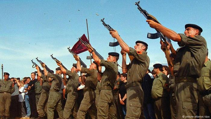 UCK fighters firing a salute at a funeral